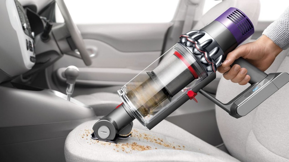 Dyson Cyclone V10⢠vacuum in handheld mode cleaning car seat Dyson Cyclone V10⢠vacuum in handheld mode cleaning car seat